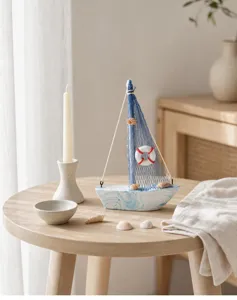 Detailed view of handmade wooden sailboat decor with blue netting, shells and coastal elements.