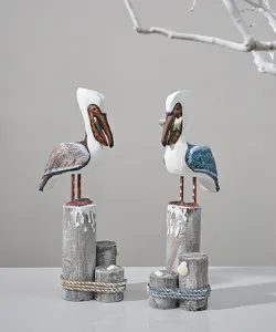 Handcrafted wooden pelican sculpture on post, Mediterranean coastal home decor ornament detail