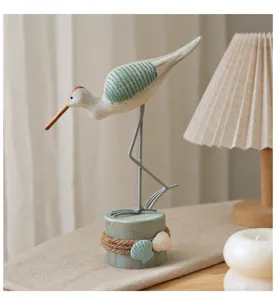 Coastal wooden seabird ornament with stump base, perfect for marine style home decor details.