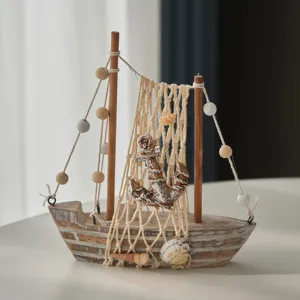 Vintage wooden sailboat model home decor with fishing net and shells, rustic desktop ornament.