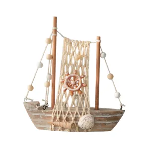 Vintage wooden sailboat model home decor, distressed light wood finish with seashells.