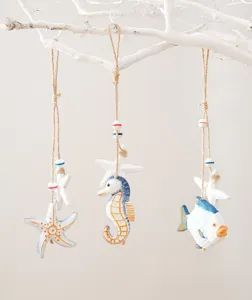 Mediterranean wooden nautical hanging ornament detail, featuring cute starfish and fish designs.