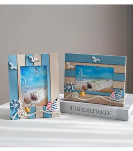 Mediterranean wooden photo frame detail showcasing nautical elements like sailboats and starfish.