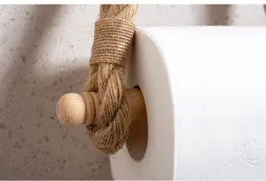 Close-up detail shot of wooden toilet paper holder with natural woven hemp rope and peg.