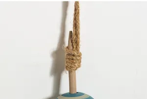 Detailed close-up of nautical wooden buoy wall hanging showing natural rope and blue stripe.
