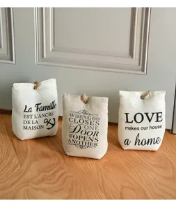 Canvas fabric door stop with inspiring quotes and rustic rope handle for home decor.