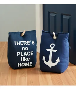 Detailed view of Mediterranean style fabric doorstops with anchor and home prints for decor.