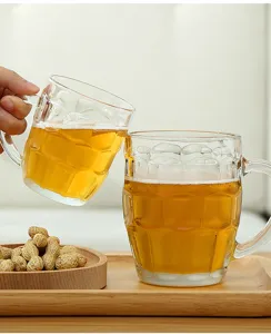 Detail shot of clear glass beer mug with dimpled pattern, comfortable handle on wooden tray.