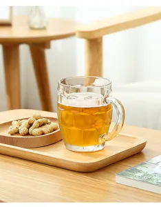 Clear glass beer mug detail showing classic dimpled texture and comfortable handle design.