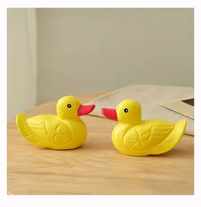 Wooden colored duck ornament detail view, cute yellow tabletop decoration for home bedroom.