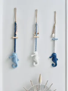 Wooden seahorse hanging decor detail, Mediterranean style home ornament with beads.