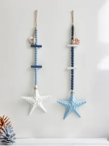Close-up of Mediterranean wooden starfish wall hanging, blue and white beads, coastal decor.