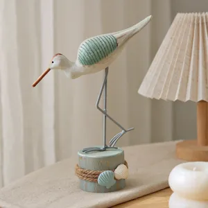 Wooden seagull bird figurine table ornament with stump base and nautical seashell decor for home.