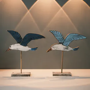 Mediterranean style wooden seagull figurines set, vintage coastal bird table decor for home.