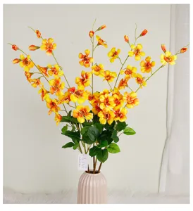 Artificial flower long branch silk flower detail view, beautiful yellow blooms and green leaves.