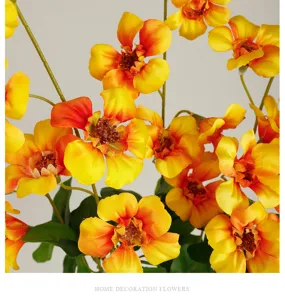 Detailed shot of artificial trumpet vine silk flower branch for home decor and photography props.
