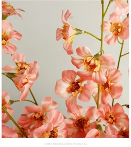 Detailed shot of artificial peach flowers long branch silk floral decor for wedding setup.