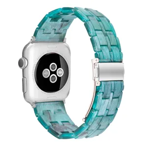 Close-up of the elegant teal resin watch strap showcasing refined links and secure metal clasp.