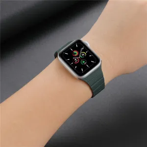 Magnetic leather loop watch band detail showing dark green color fitted on smart watch firmly.