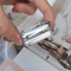 Silver metal bumper case detail for smart watch, protective aluminum frame accessory close up.