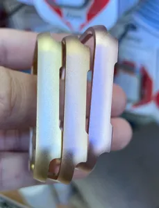 Detail shot of aluminum metal bumper cases for smart watch, showing matte metallic gradient finish.
