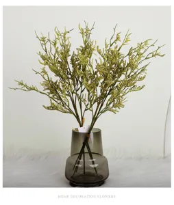 Detailed view of artificial limonium flower in glass vase, ideal for home decor and props.