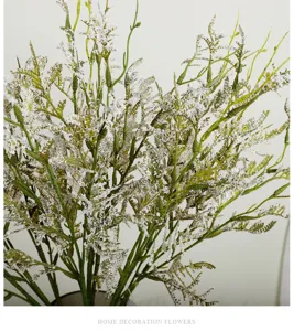 Detailed close-up view of artificial frosted greenery branch, perfect for home table decor.