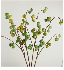 Detailed view of artificial pumpkin fruit branch, natural texture and festive home decor.