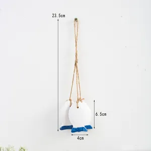 Detailed view of Mediterranean style wooden fish hanging decor featuring natural twine rope.