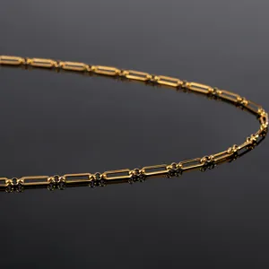 Close-up detail of gold stainless steel paperclip and bead chain DIY jewelry accessory link.