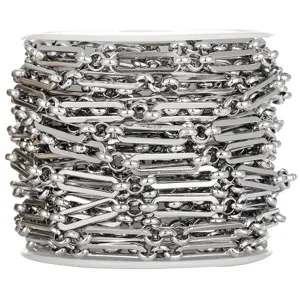 Close-up view of stainless steel paperclip and round pearl chain spool for DIY jewelry crafting.