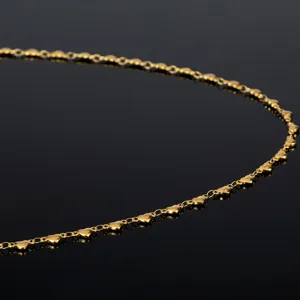 Close-up detail of a delicate gold heart chain, ideal for DIY handmade jewelry accessories.