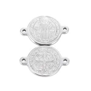 Detailed view of stainless steel St. Benedict medal two-hole connector for DIY jewelry making.