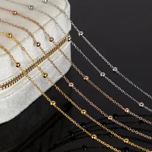 Close-up detail of stainless steel beaded chains in gold, rose gold and silver for DIY jewelry.
