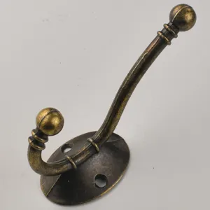 Antique bronze metal coat hook detail, vintage wall mounted hook with fixing base.