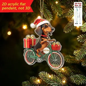 Vista detallada del adorno navideño de acrílico con perrito salchicha en bicicleta.