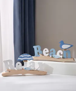 Detailed view of Mediterranean coastal wooden table decor with Relax and Beach letters and birds.