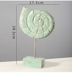 Wooden conch seashell sculpture desktop ornament coastal home decor piece detail shot.