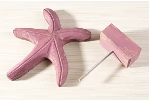 Wooden starfish tabletop ornament detail view, rustic pink coastal decor for kids room home.
