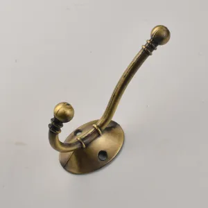 Bronze vintage coat hook detail shot, antique wall mounted double robe hardware hook.