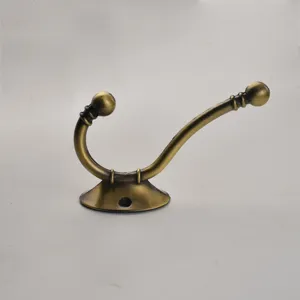 Close-up of European antique metal coat hook, retro double hook wall mounted hardware accessory.