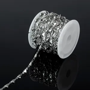 Close-up detail of silver heart chain roll, stainless steel DIY jewelry making component spool.