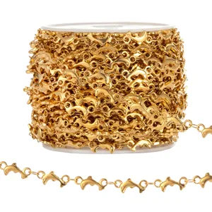 Close-up view of gold stainless steel dolphin shape chain link for DIY jewelry crafts.