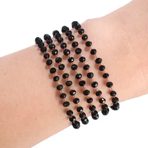 Detailed view of black faceted crystal bead chain bracelet for stylish DIY jewelry design.