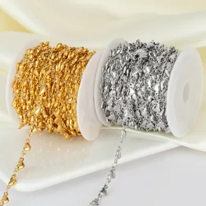 Stainless steel heart chain detail close up, gold and silver spool jewelry DIY components.