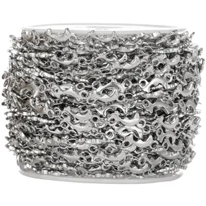 Detailed view of stainless steel dolphin link chain rolled on a spool for DIY jewelry making.