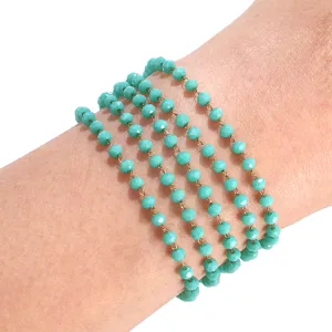Crystal glass beaded multi-layer bracelet detail shot showing turquoise faceted crystal charm design.