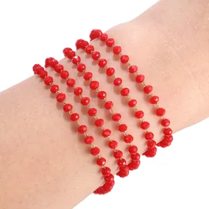 Close-up detail of multi-strand red crystal glass bead chain bracelet or necklace accessory.
