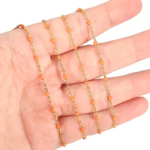 Stainless steel gold plated chain with orange enamel beads for DIY jewelry making supplies.