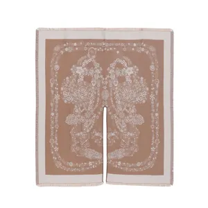Close-up detail of women's split cape shawl with intricate white floral print and stylish fringe.